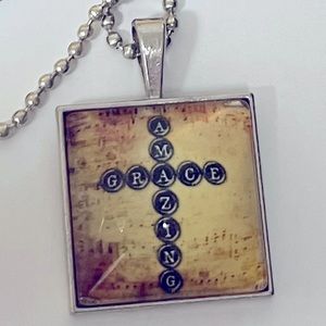 Amazing Grace cross necklace 23” chain 1” square pendant w/ clear dome front.